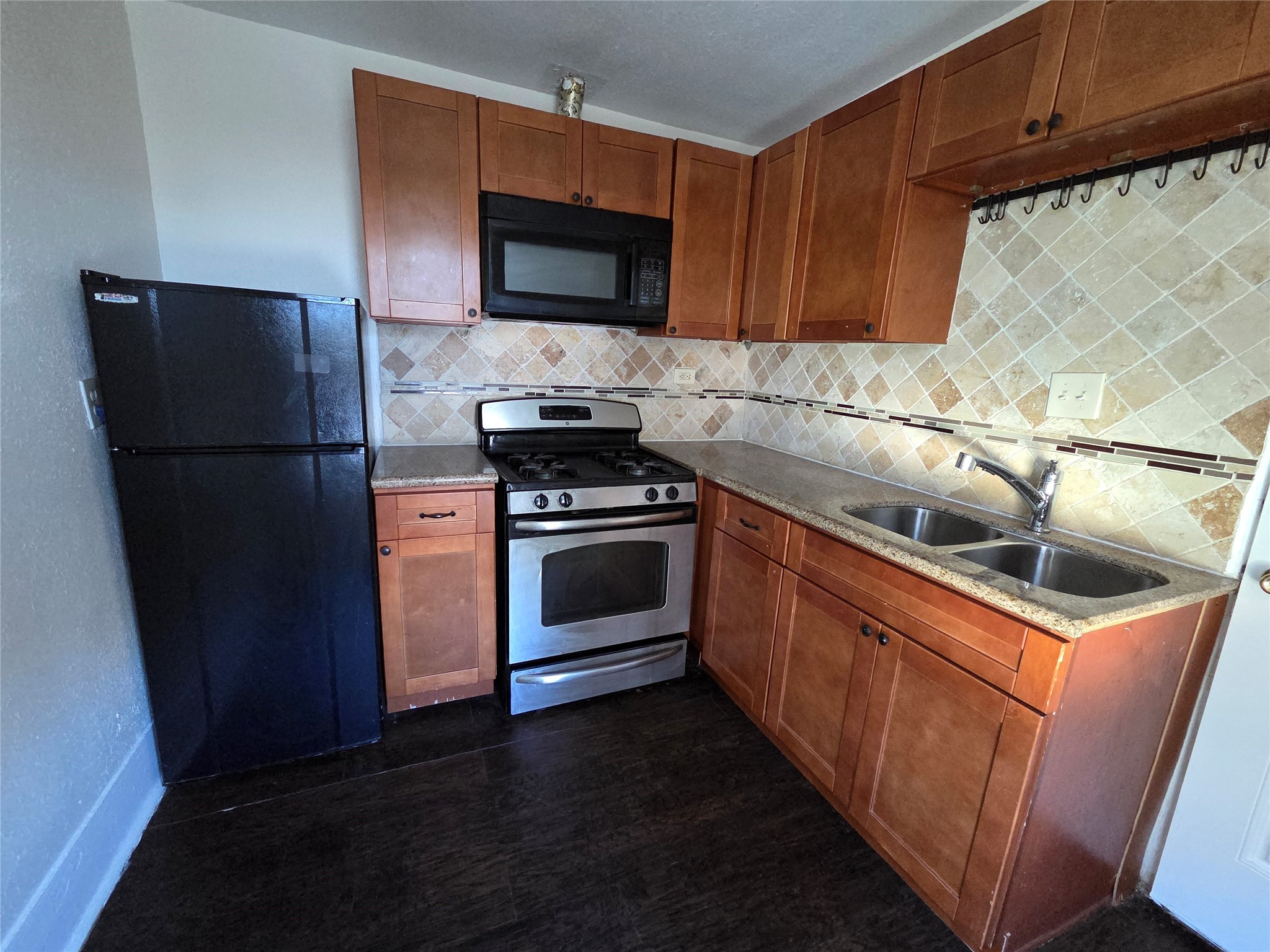 a kitchen with a sink and steel appliances