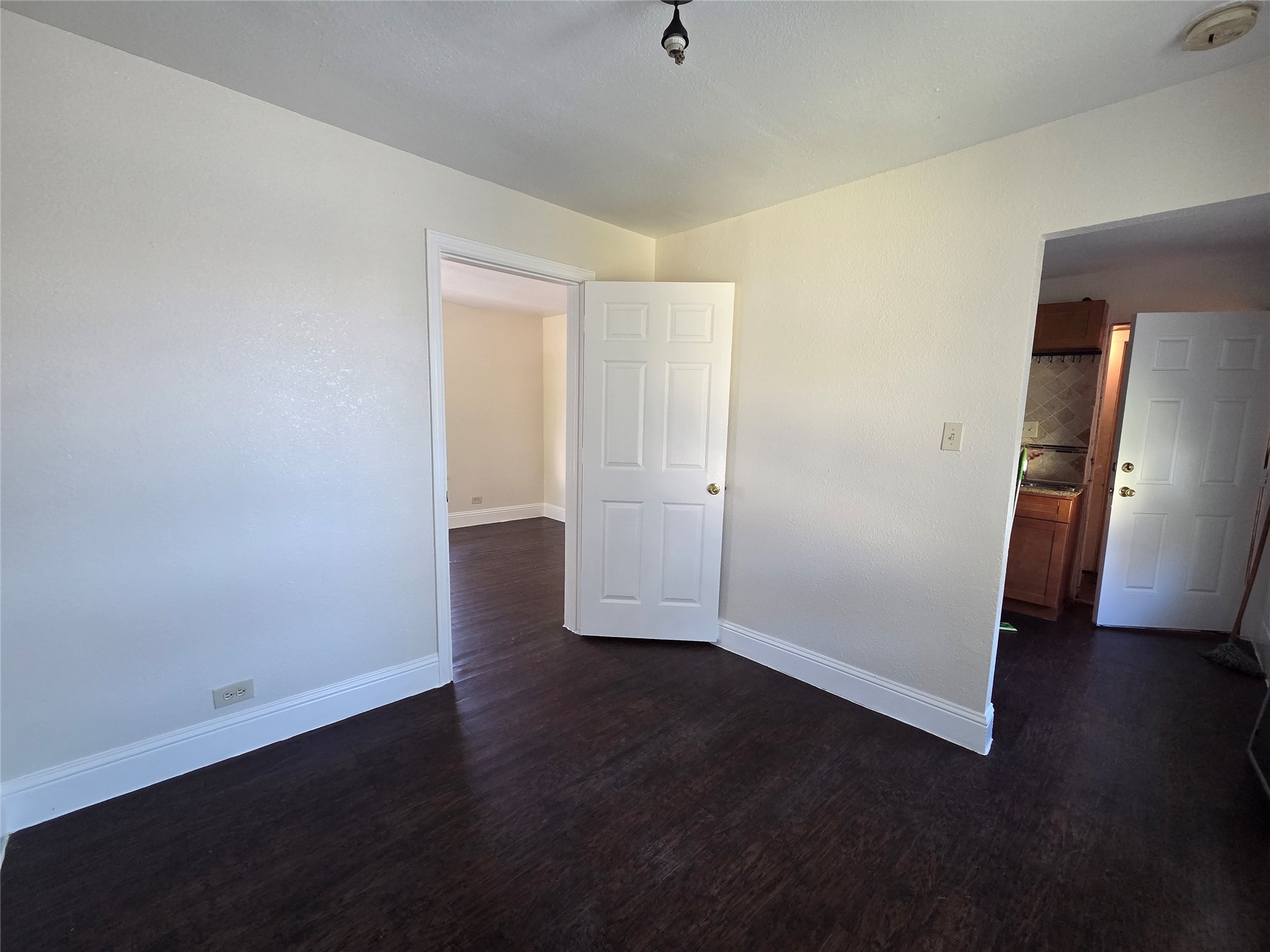 302 71st Street, Unit 2 Houston, TX 77011 - Photo 3 of 7 an empty room with wooden floor and closet