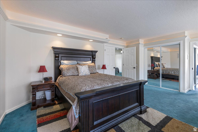 19 South 820 East Tooele, UT 84074 - Photo 6 of 46 Bedroom featuring dark carpet, a closet, and a textured ceiling