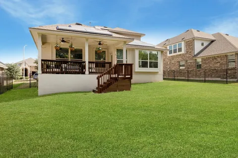 a view of a house with backyard and porch