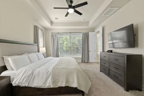 a bedroom with a bed and a flat screen tv