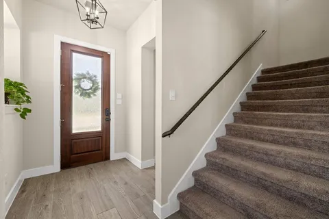 a view of entryway and hall with wooden floor