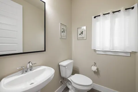 a bathroom with a sink a mirror and a toilet