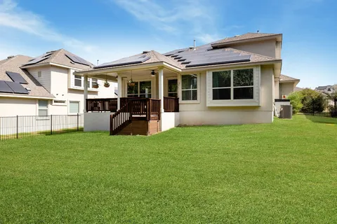 a front view of a house with a garden and yard