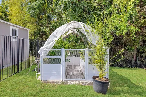a view of a small house with a garden