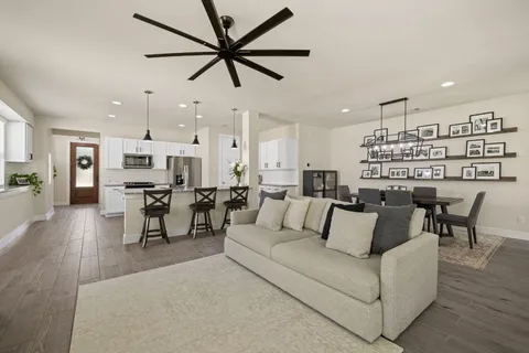 a living room with furniture kitchen view and a dining table