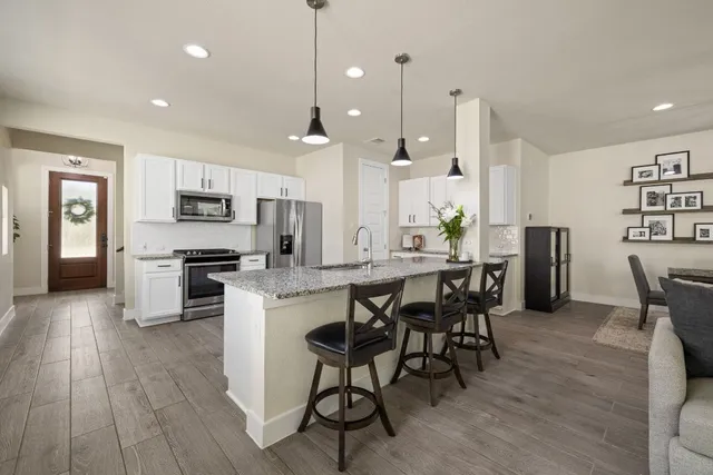 a large kitchen with a table and chairs