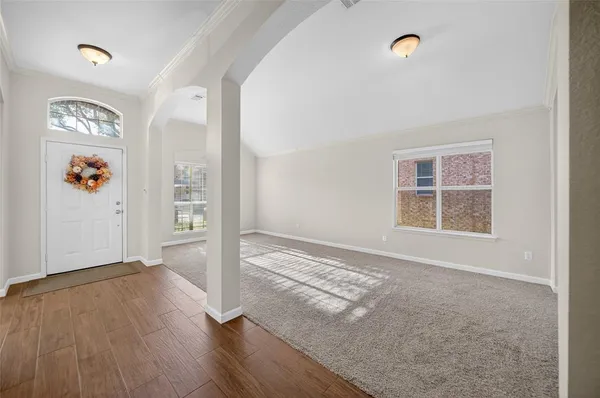 an empty room with windows and closet