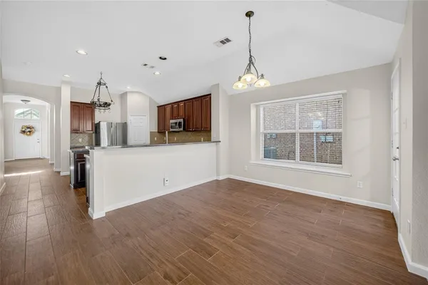 a view of a kitchen with microwave and cabinets