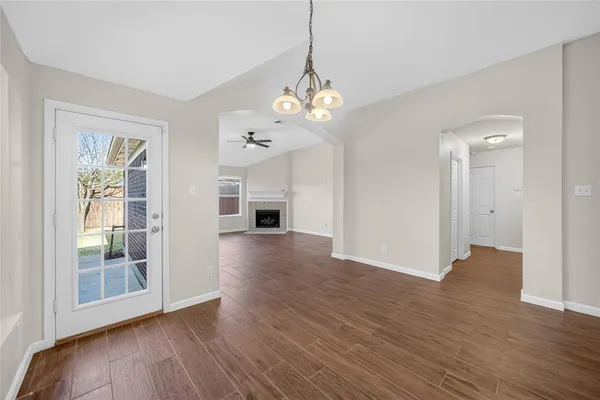 a view of a livingroom with wooden floor and a large window