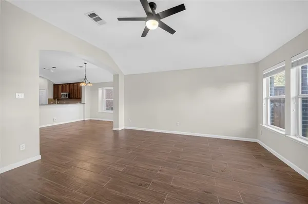 wooden floor in an empty room with a window