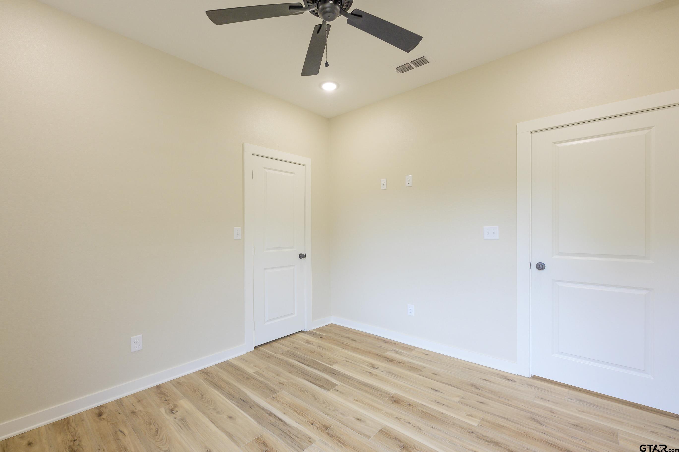454 Crescent Bullard, TX 75757 - Photo 19 of 44 a view of empty room with wooden floor