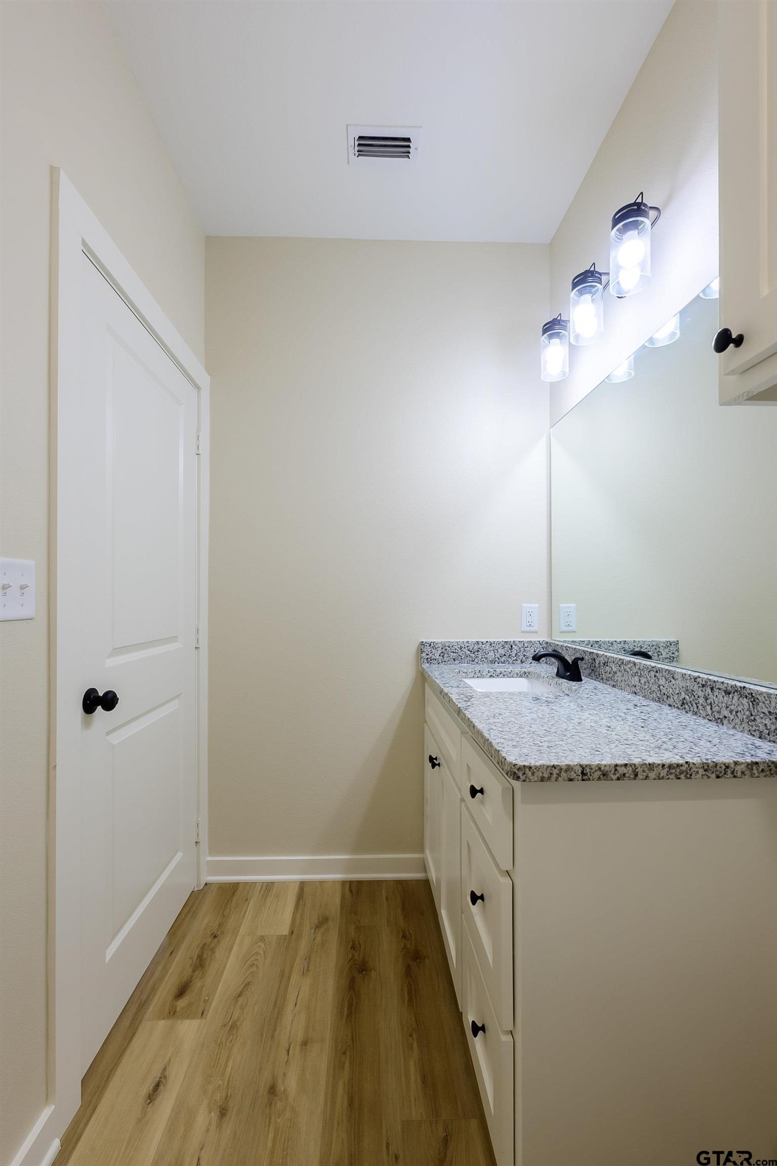454 Crescent Bullard, TX 75757 - Photo 23 of 44 a bathroom with a granite countertop sink and a mirror