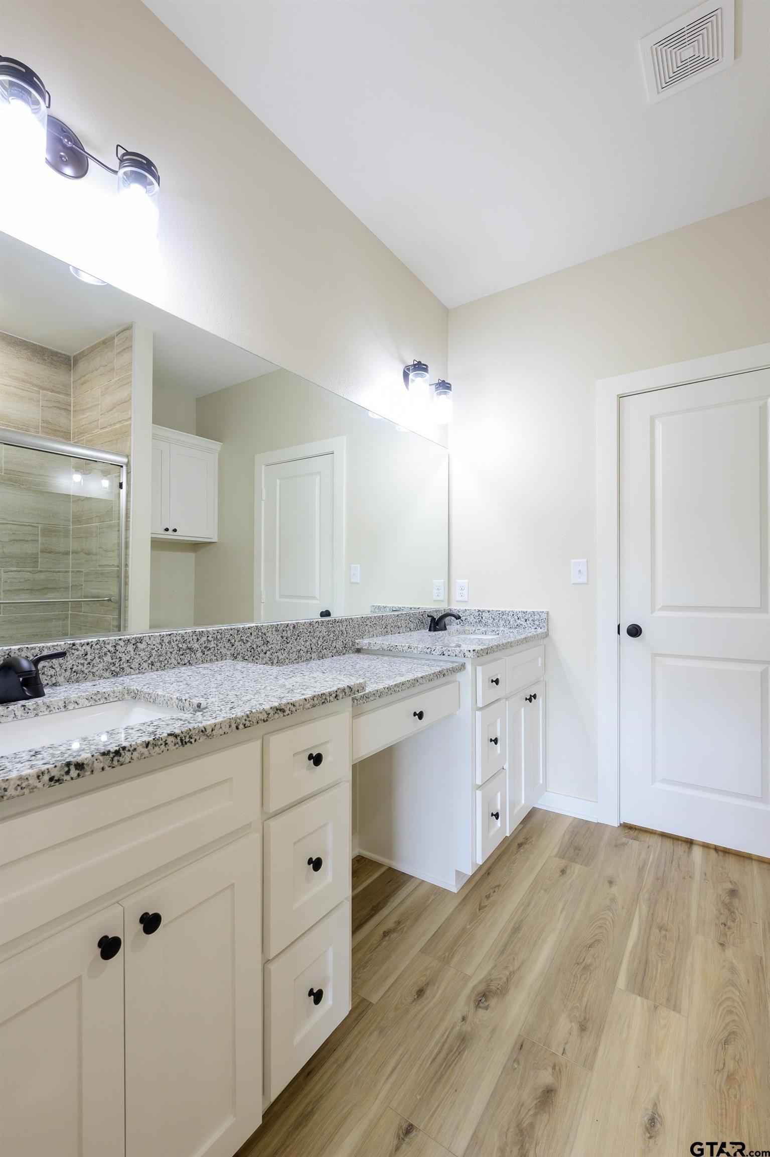 454 Crescent Bullard, TX 75757 - Photo 24 of 44 a bathroom with a granite countertop sink and a mirror