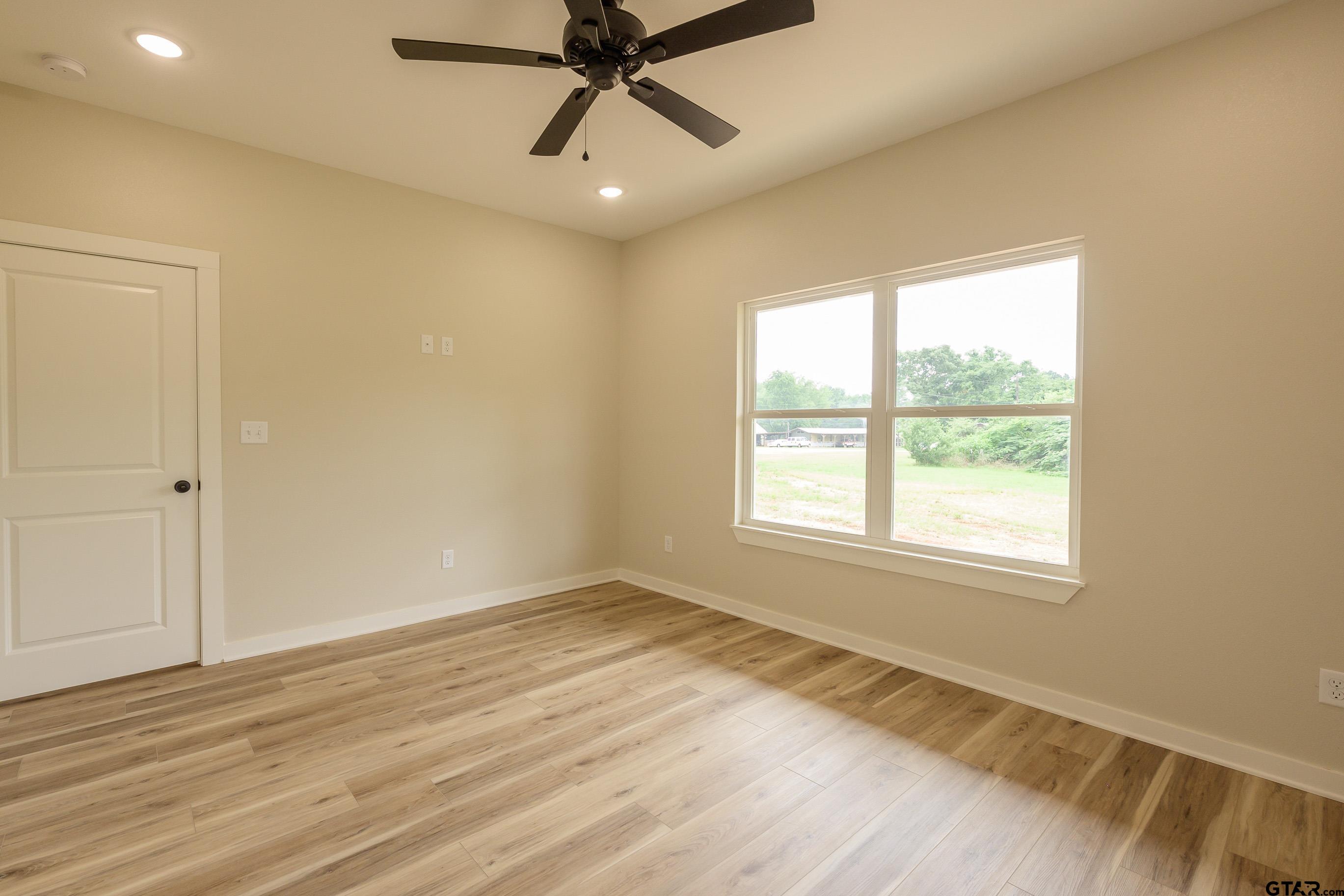 454 Crescent Bullard, TX 75757 - Photo 30 of 44 a view of an empty room with wooden floor and a window
