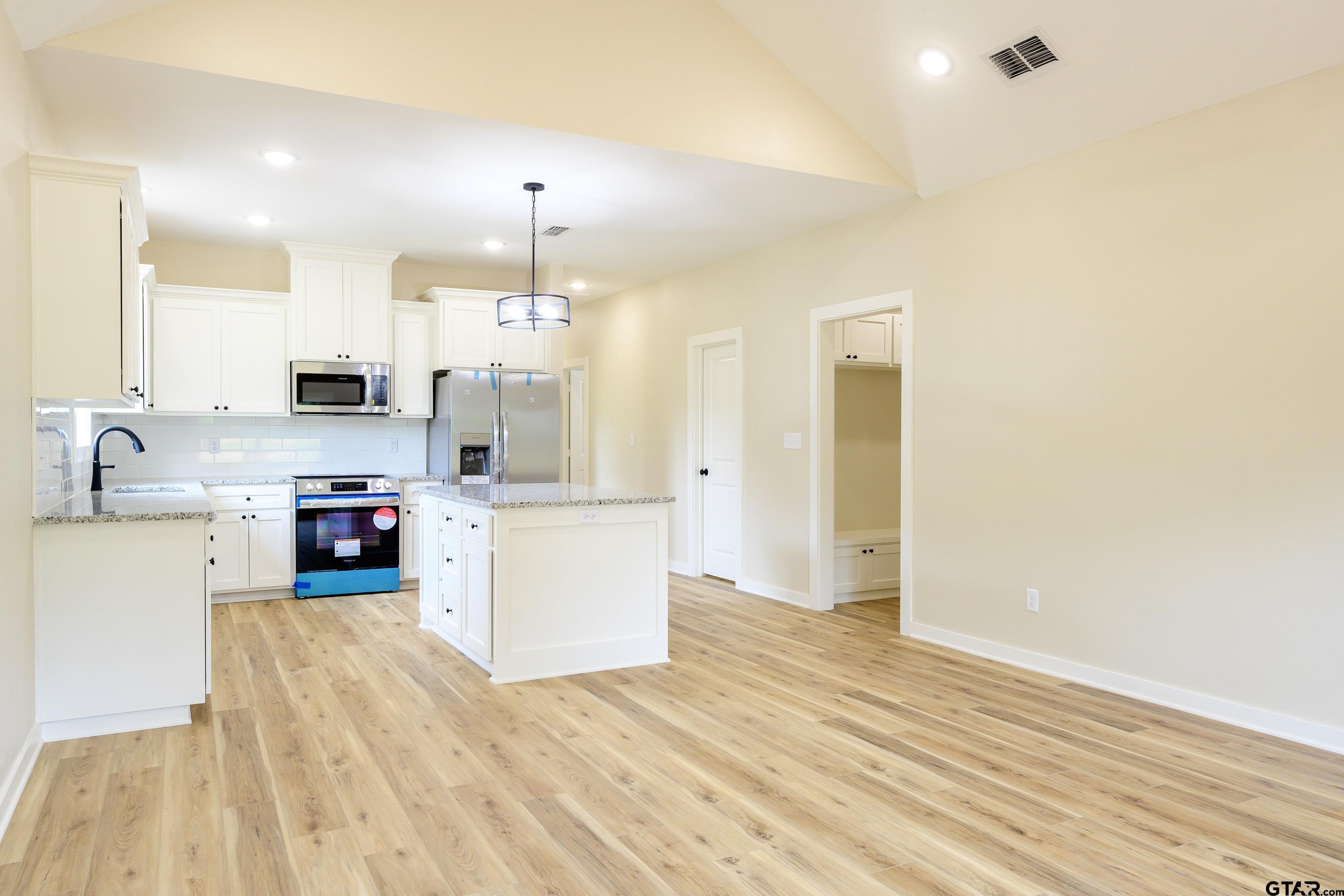 454 Crescent Bullard, TX 75757 - Photo 3 of 44 a large kitchen with cabinets a sink and a stove