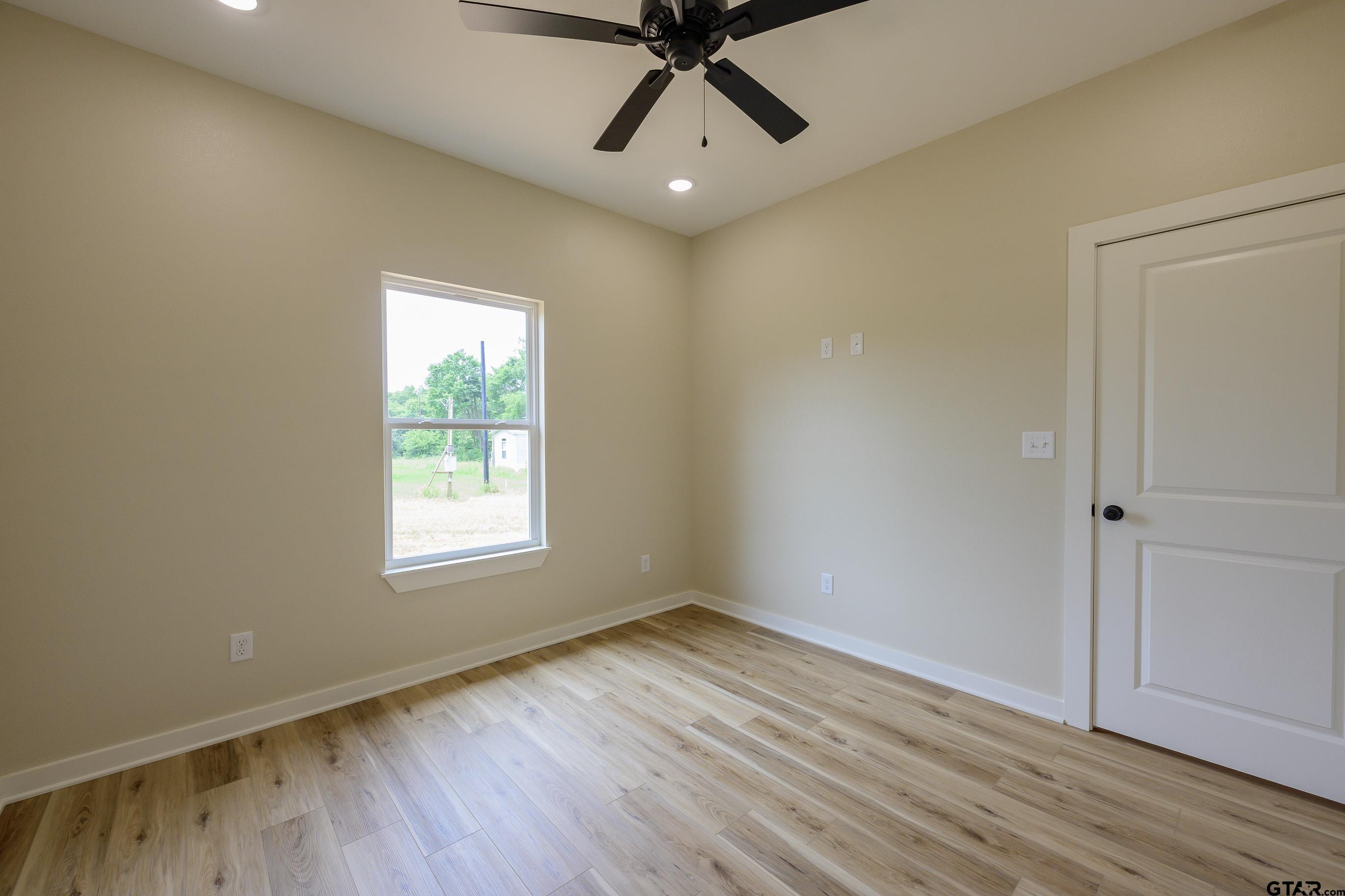 454 Crescent Bullard, TX 75757 - Photo 37 of 44 a view of an empty room with wooden floor and a window
