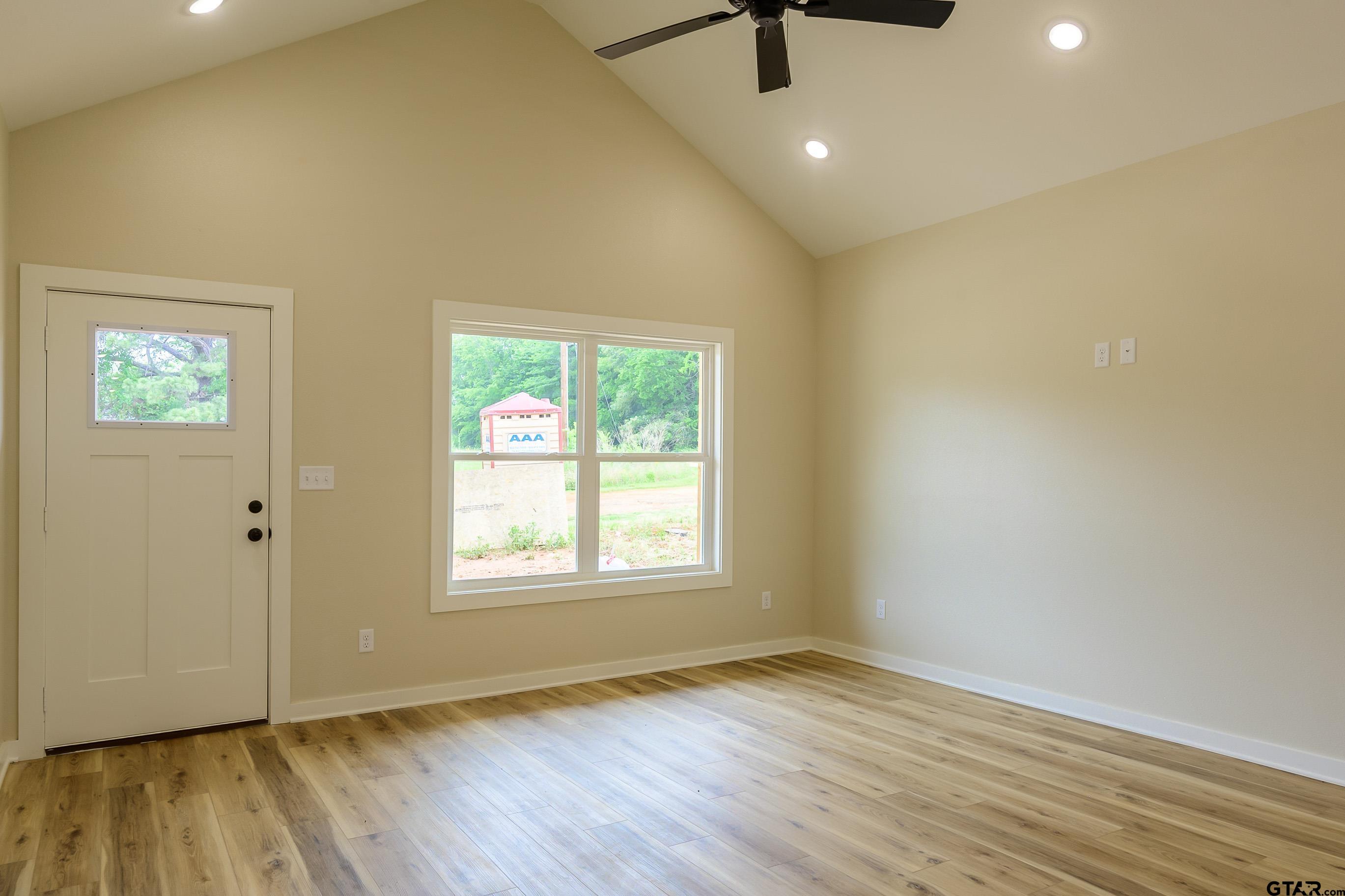 454 Crescent Bullard, TX 75757 - Photo 4 of 44 an empty room with wooden floor and windows