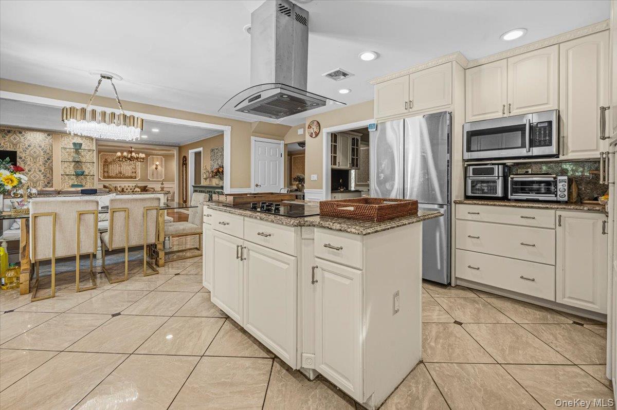626 Caledonia Road Dix Hills, NY 11746 - Photo 16 of 49 a kitchen with stainless steel appliances kitchen island granite countertop a stove a sink and a refrigerator