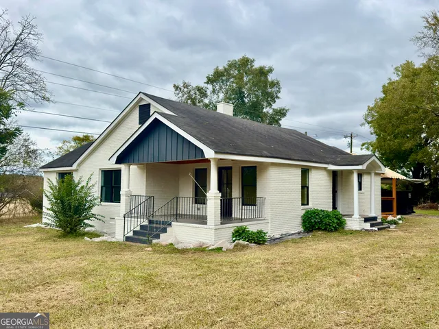 a front view of house with yard and green space