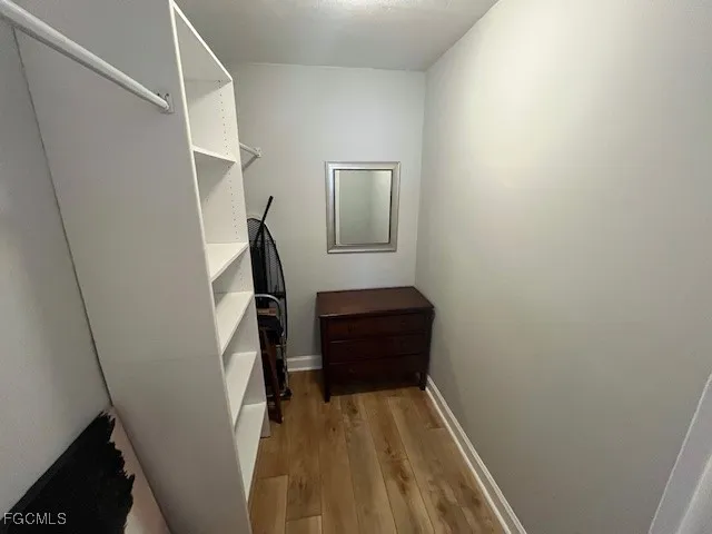 a view of a patio with a table and chairs under an umbrella