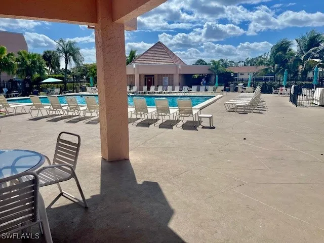 a view of a patio with dining table and chairs