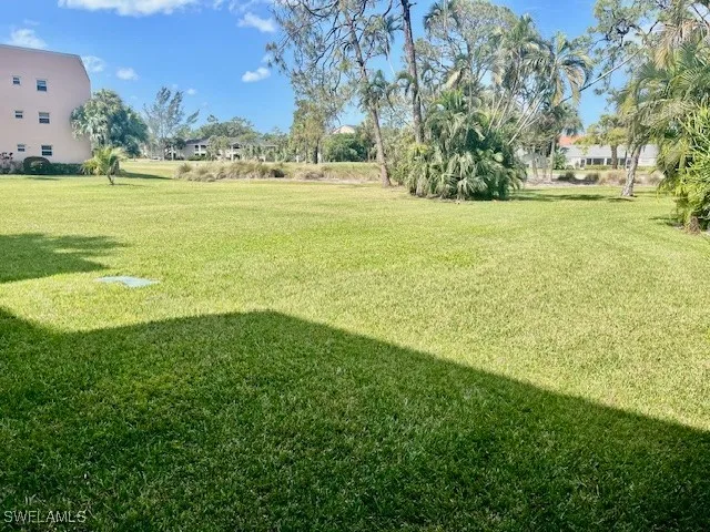 a living room with fireplace furniture and large windows