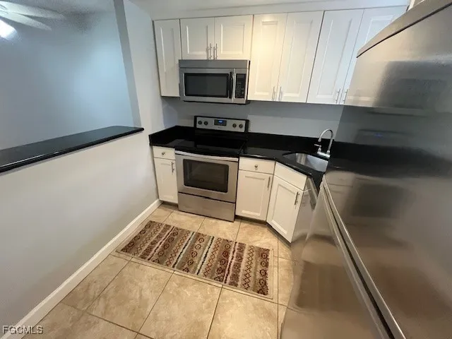 a kitchen with a sink and a stove top oven