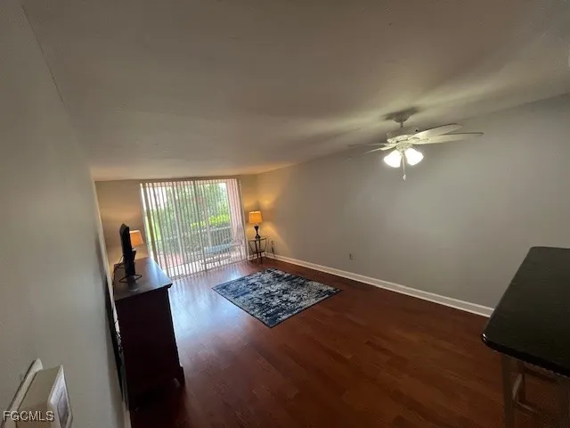 a view of a livingroom with wooden floor and a window