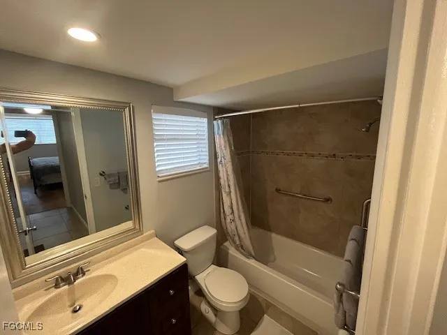 a bathroom with a sink a toilet a mirror and shower
