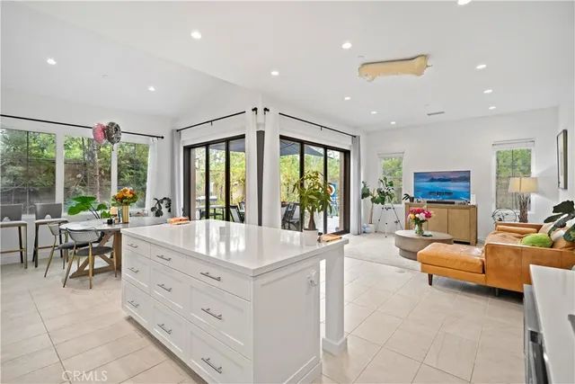 a kitchen with white cabinets and appliances
