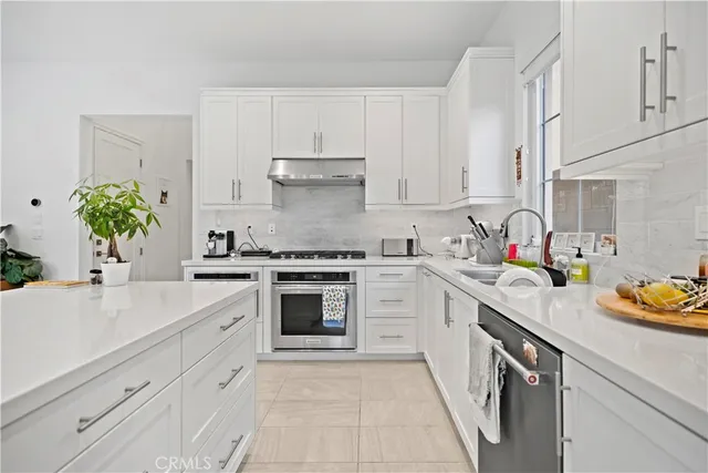a kitchen with a sink and chairs
