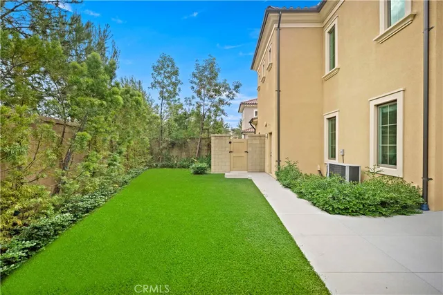 a view of a patio with table and chairs and potted plants with wooden fence