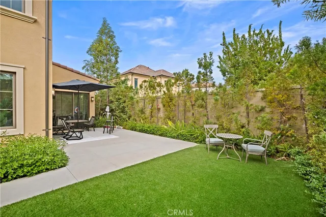 a view of an outdoor dining space with furniture and umbrella