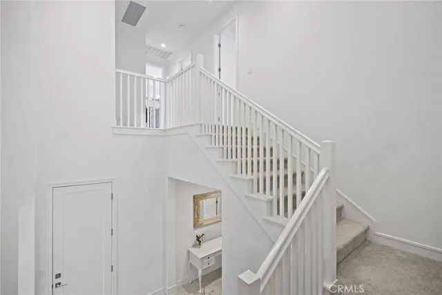 a view of a hallway with wooden floor and windows