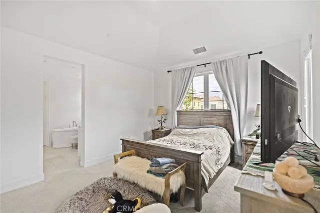 a large white bathroom with a large tub sink and mirror