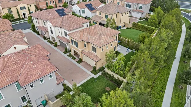 an aerial view of a residential houses with city street