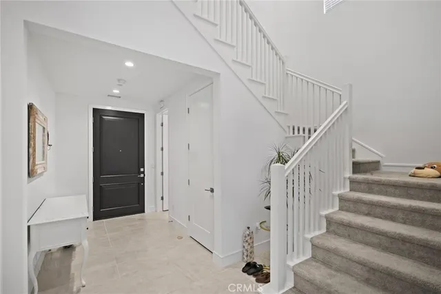 a view of staircase with white walls and windows
