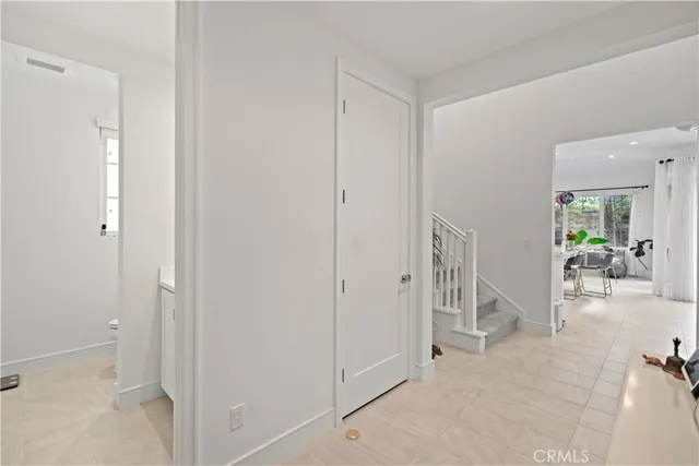 a living room with furniture a flat screen tv and a window