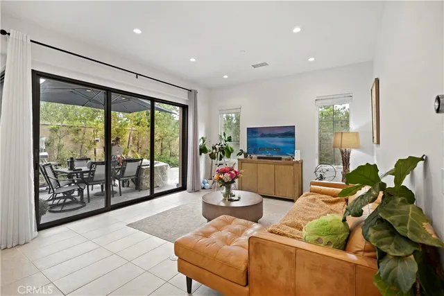 a living room with furniture and a floor to ceiling window