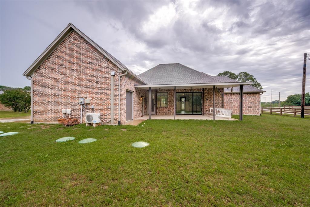 444 Ben Boyd Road Argyle, TX 76226 - Photo 26 of 28 a front view of a house with a garden