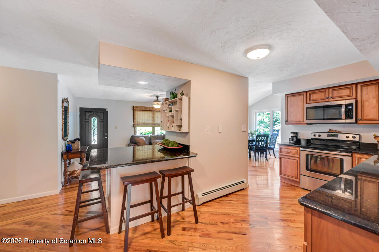 3660 Aberdeen Road Moscow, PA 18444 - Photo 22 of 68 a kitchen with stainless steel appliances a table and chairs in it