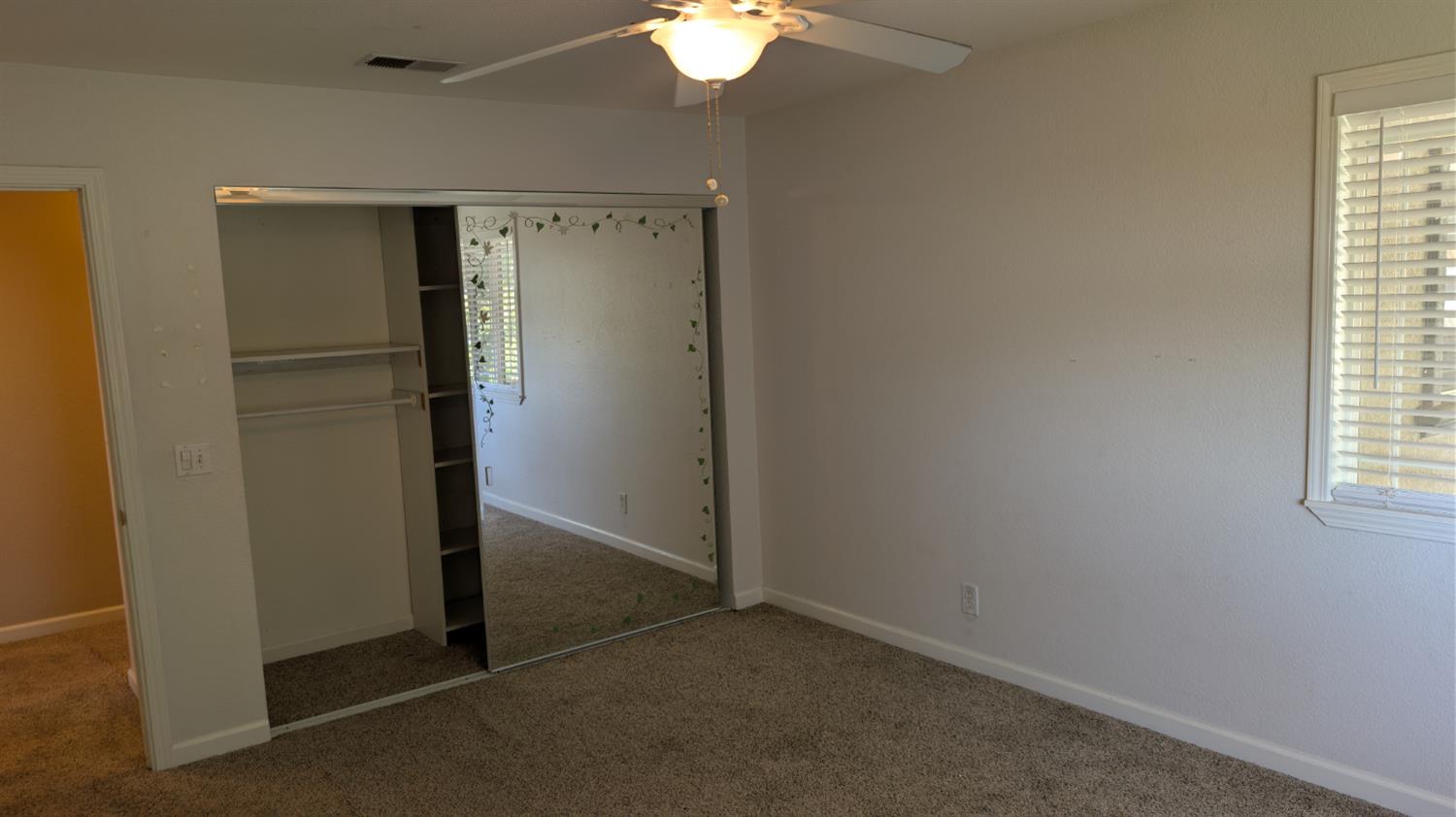 3248 Sudbury Road Cameron Park, CA 95682 - Photo 25 of 41 an empty room with closet and a chandelier fan