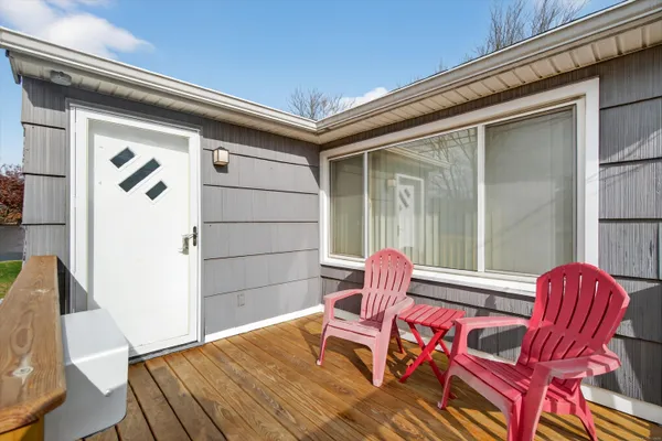 a balcony with furniture and wooden floor