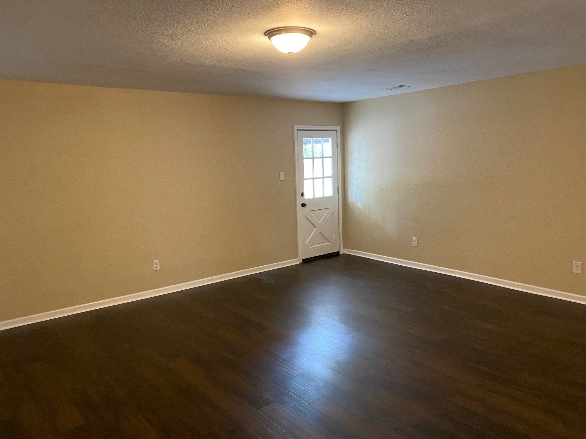 112 County Road 921 Angleton, TX 77515 - Photo 9 of 13 an empty room with wooden floor and windows