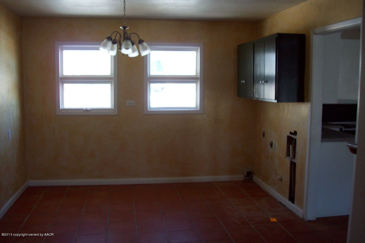 4202 South Bonham Street Amarillo, TX 79110 - Photo 3 of 8 an empty room with wooden floor and windows