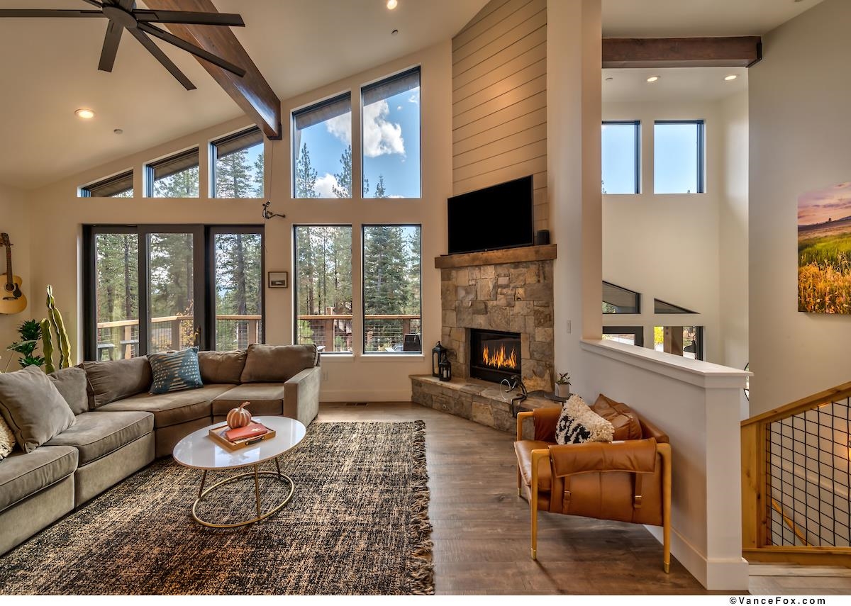 11964 Cavern Way Truckee, CA 96161 - Photo 2 of 21 a living room with furniture fireplace and a flat screen tv