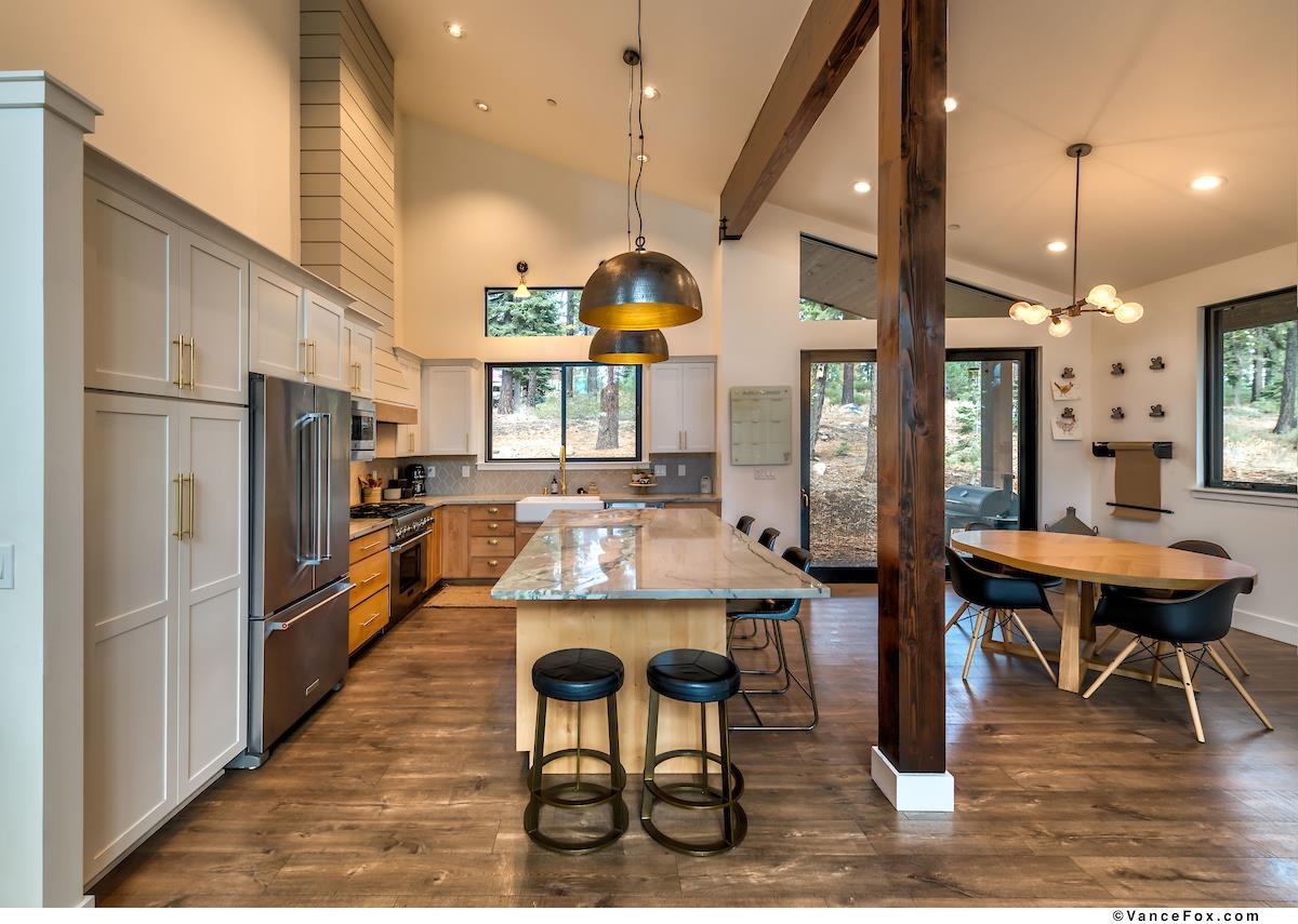 11964 Cavern Way Truckee, CA 96161 - Photo 3 of 21 a kitchen with stainless steel appliances kitchen island granite countertop dining table chairs and a large window