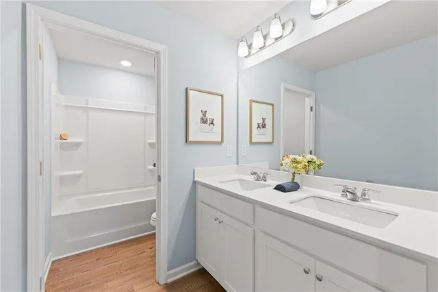 a bathroom with a sink vanity tub and shower