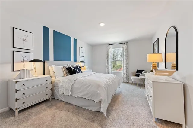 a spacious bedroom with a bed and a large window